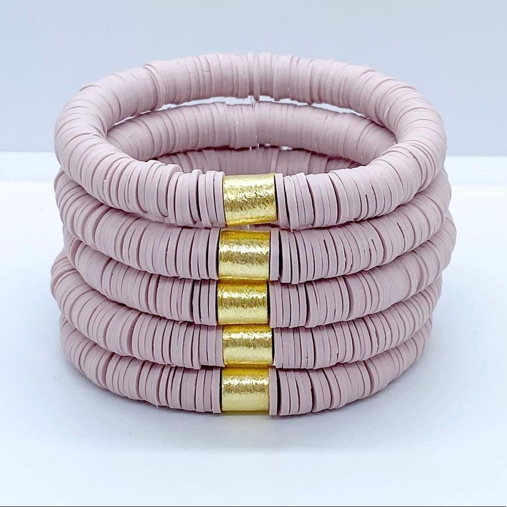 Mauve heishi stack bracelets.